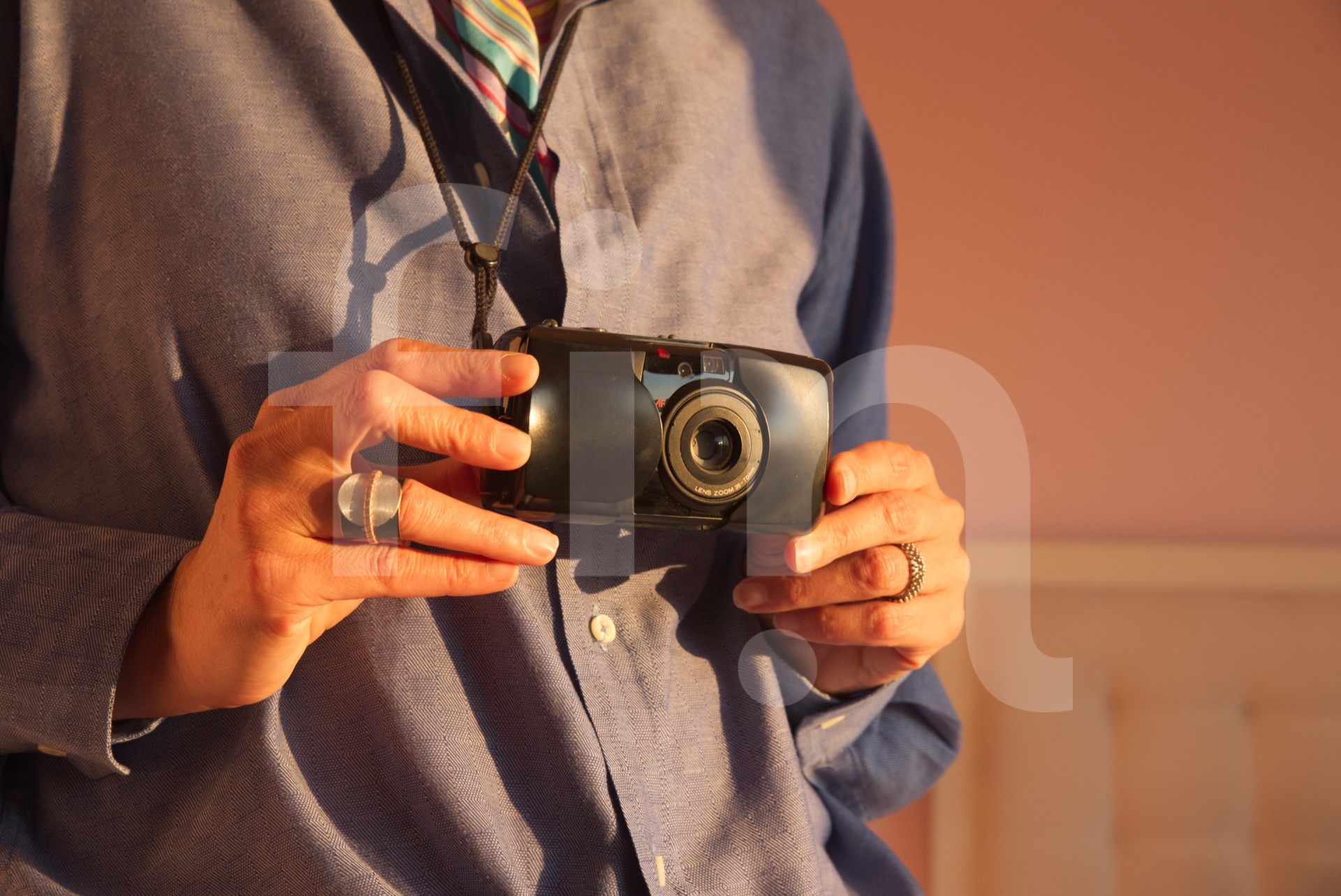 Female hands hold an analog camera