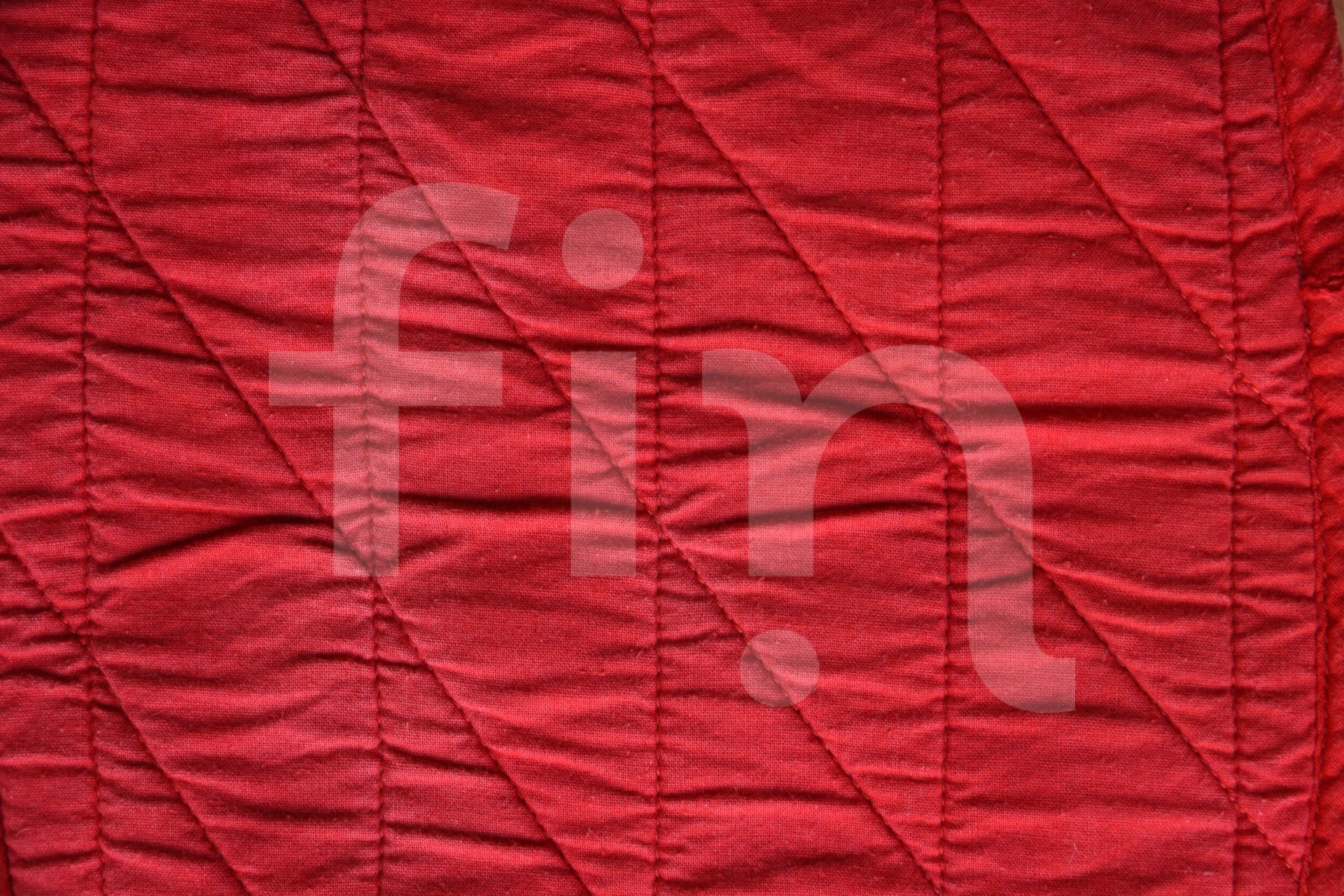 Red textile texture with stitched vertical rhombuses