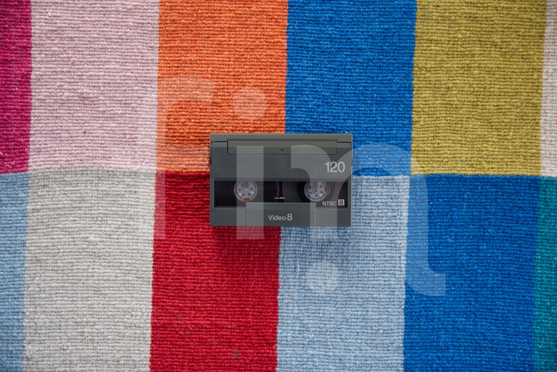 Small video cassette on a colorful background