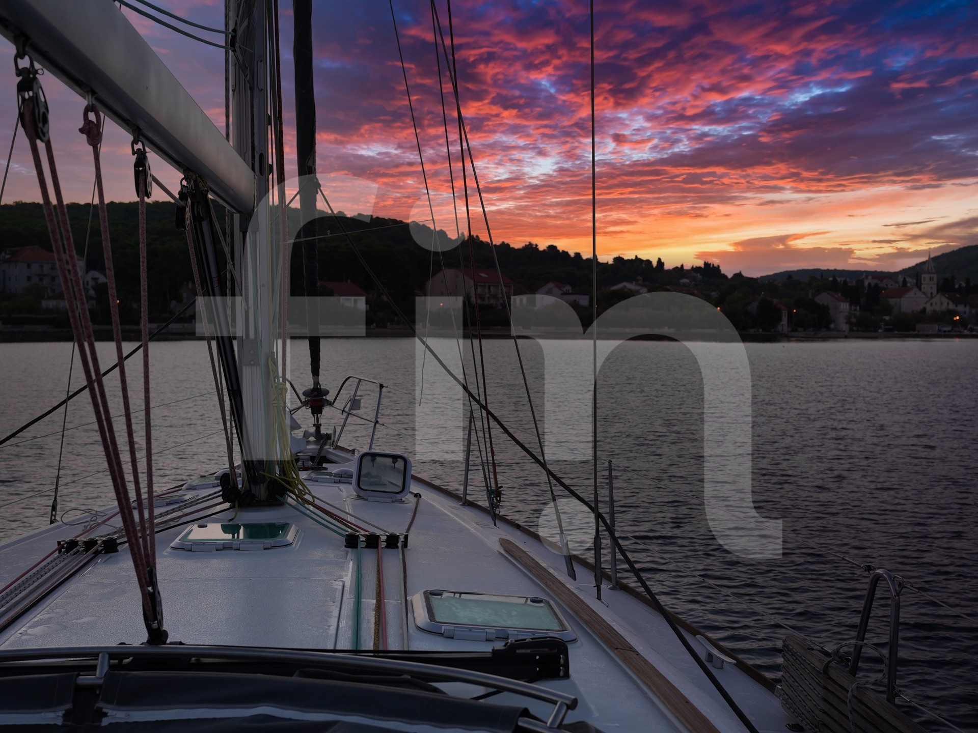 Bow of a sailboat with sunset