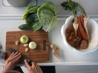 Cutting vegetables on a wooden board on a sailboat