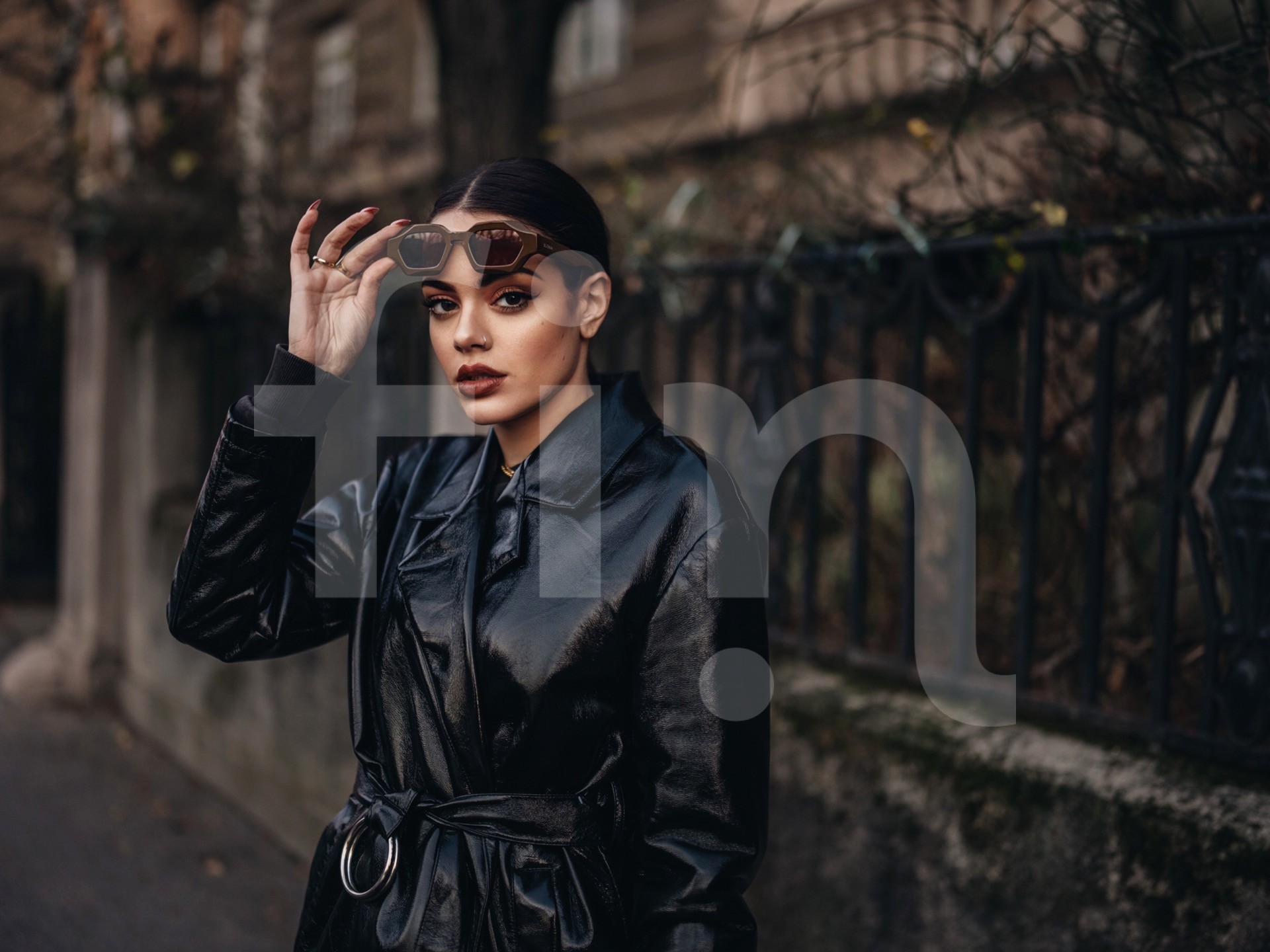 Black coat fashion girl with sunglasses and dark makeup city portrait