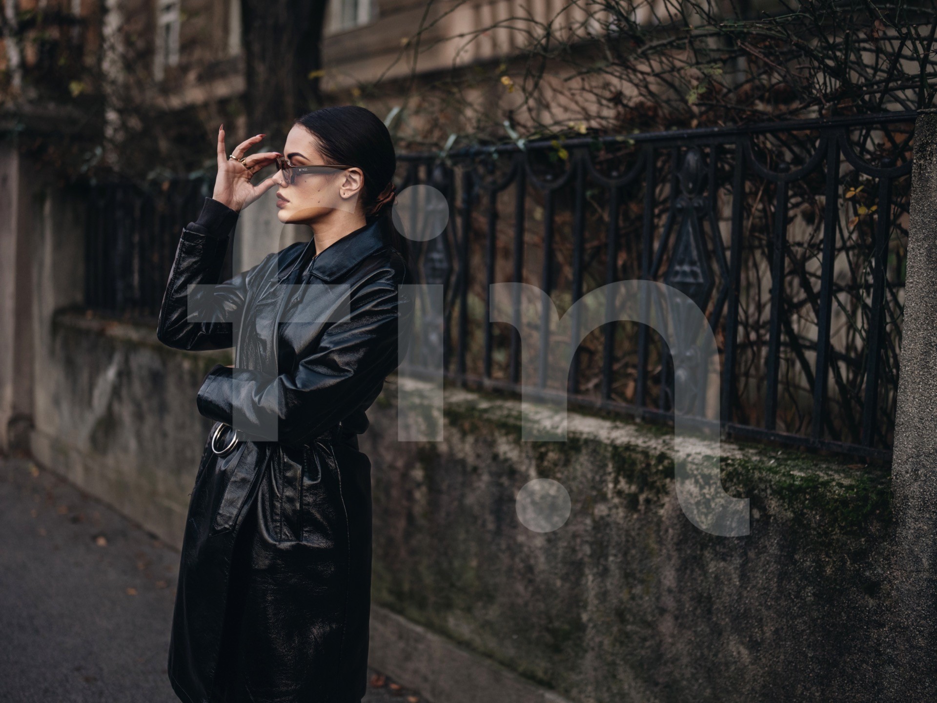 Black coat fashion girl with sunglasses and dark makeup on the street