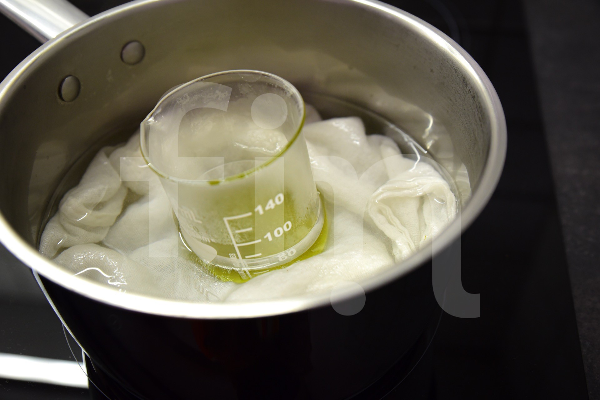 Dissolving the oil in a warm bath in a laboratory beaker