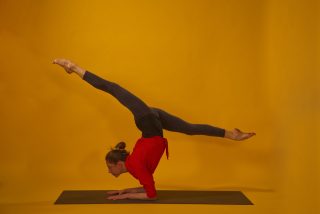 Yoga pose Vrischikasana Scorpion with stretched legs