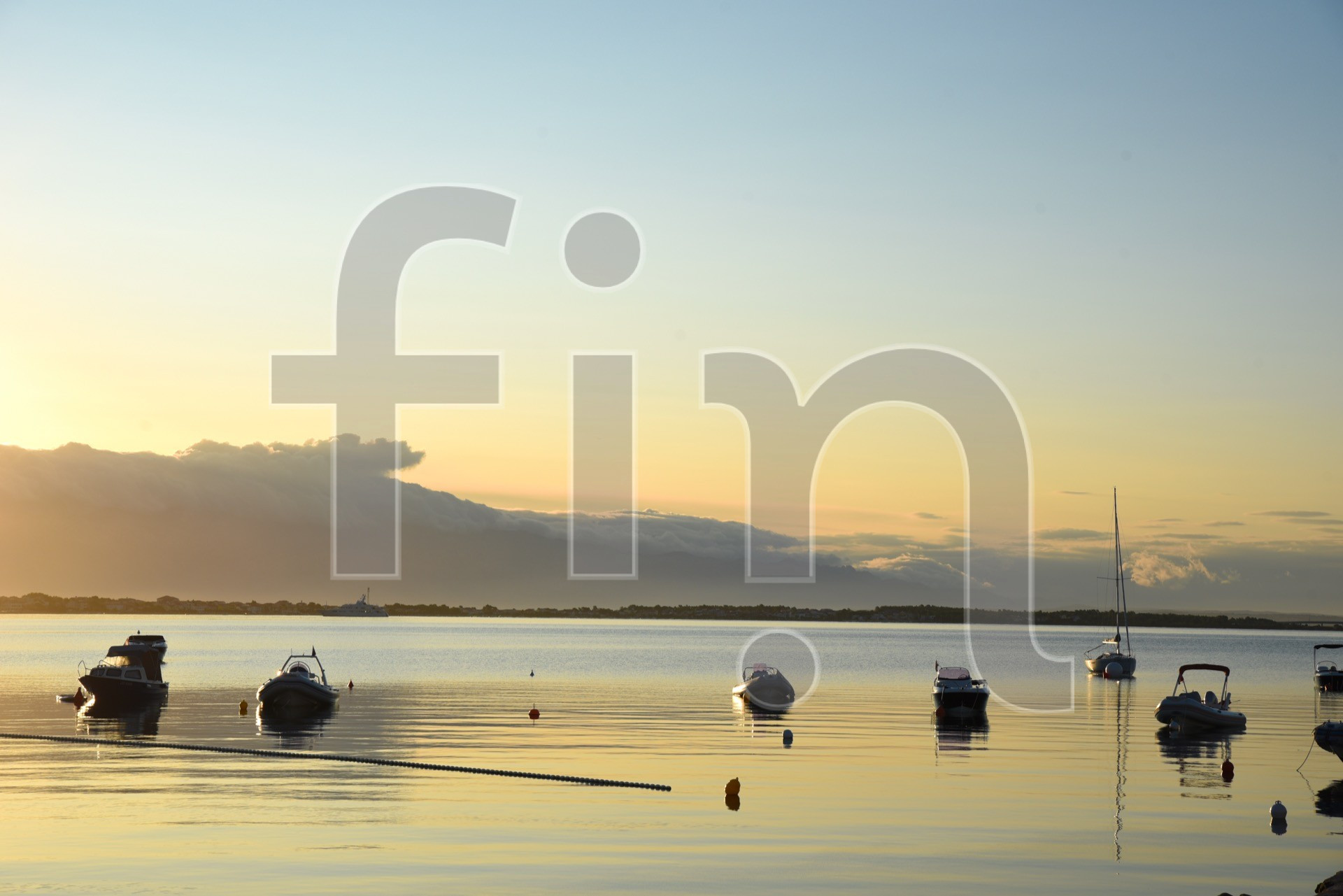 Boats at sea at sunrise golden hour