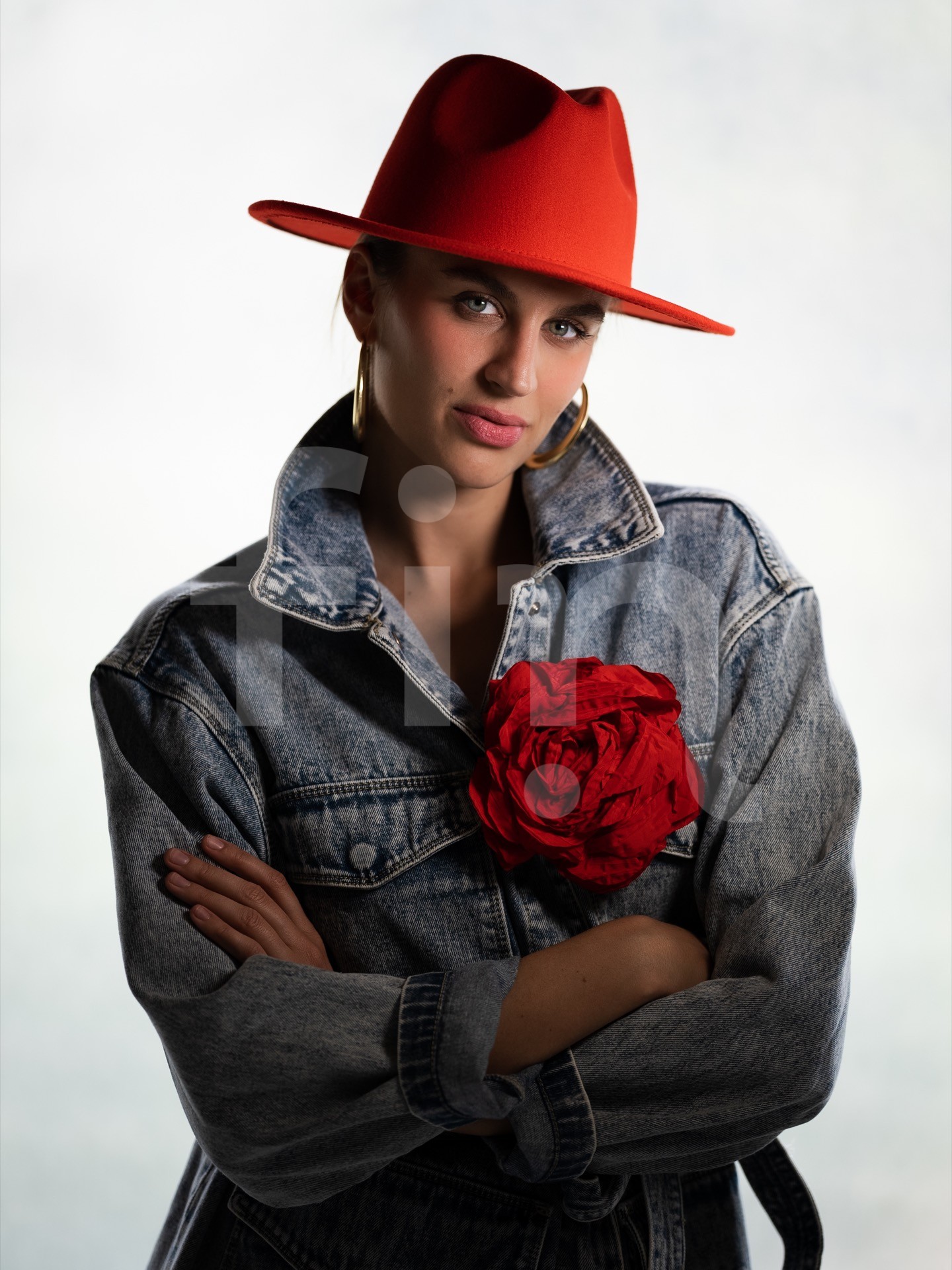 Girl with a red hat and a big rose on a denim jacket