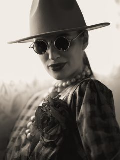 Sepia photo of a girl with sunglasses