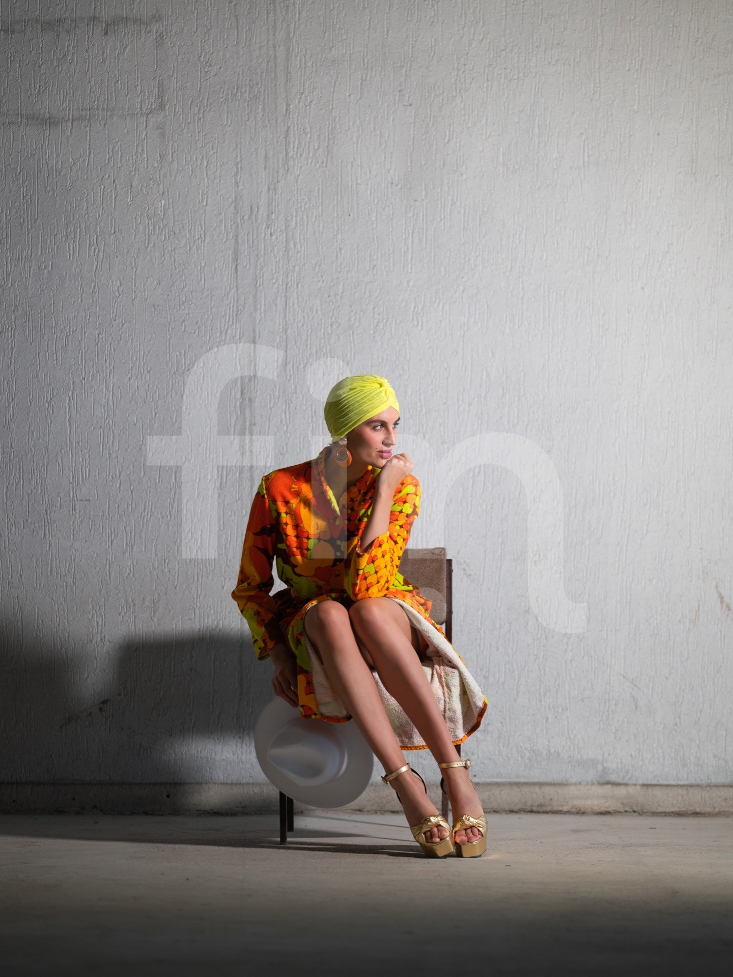 Yellow-orange styling girl in a spacious concrete hall