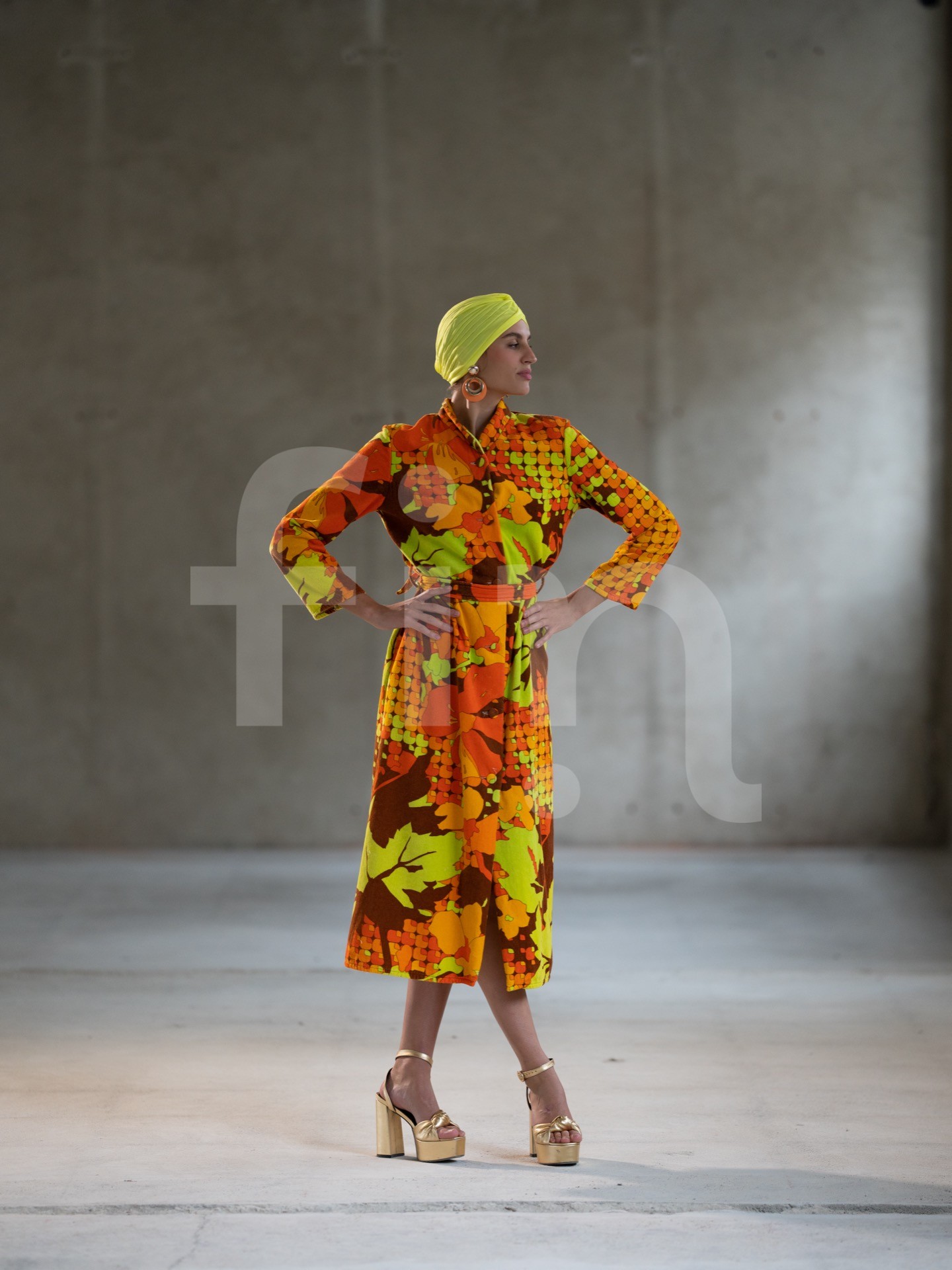 Yellow-orange styling girl in a spacious concrete hall