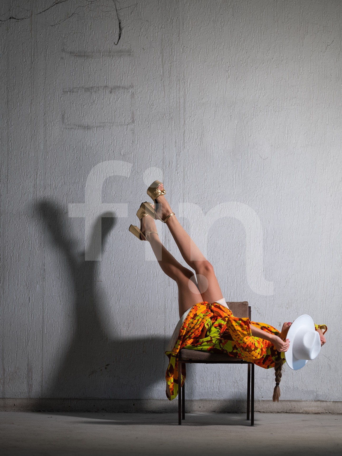 Yellow-orange styling girl in a spacious concrete hall