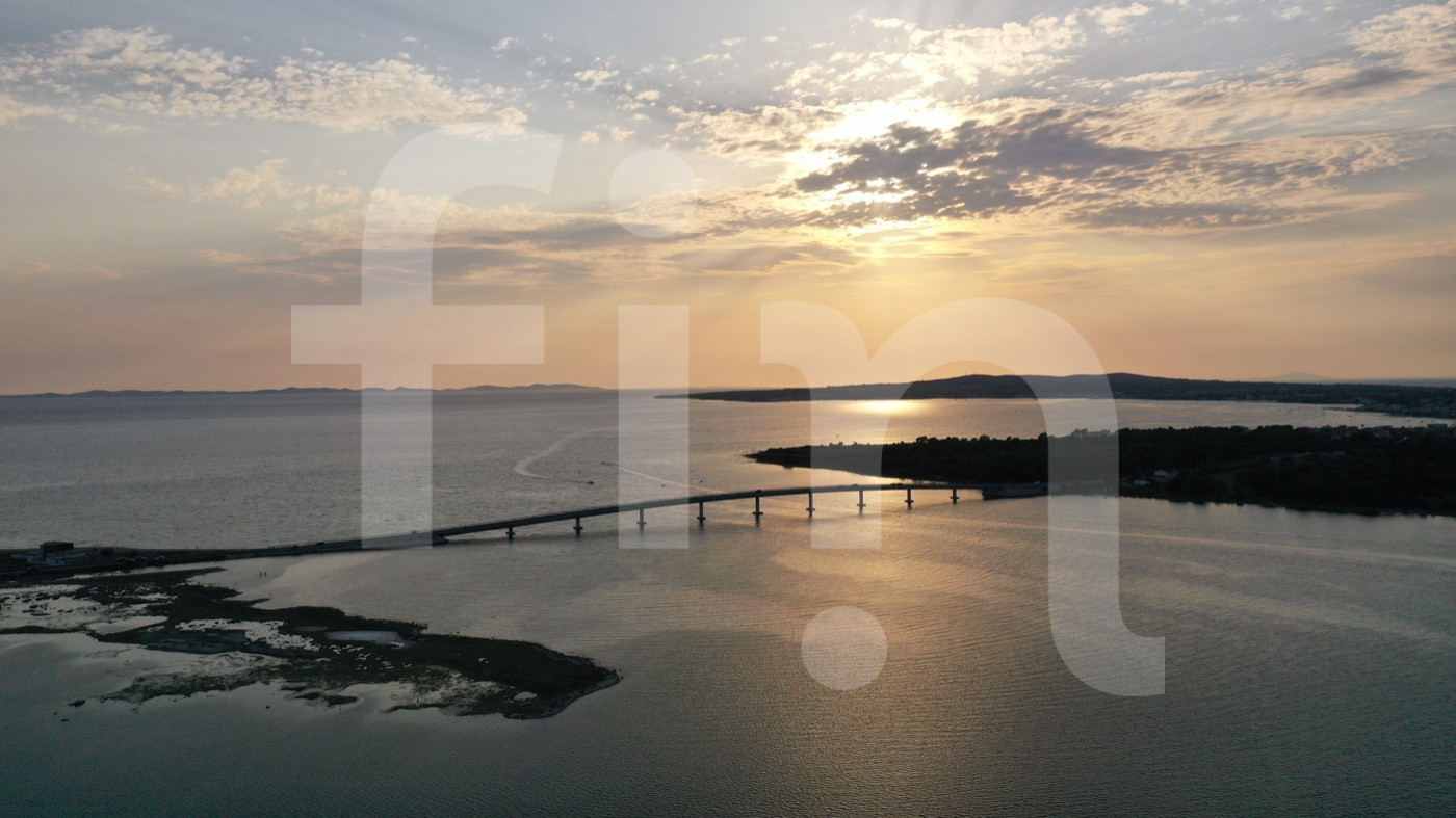 sunset through clouds sea